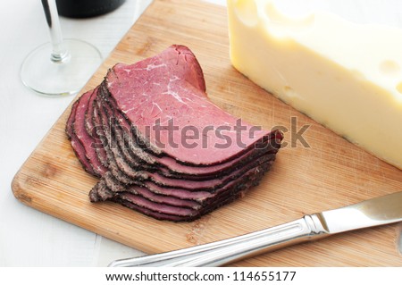 Deli meat and cheese on cutting board horizontal