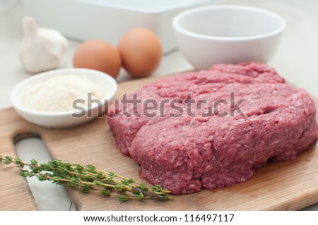 Raw ground meat with eggs and components for cooking horizontal