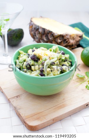 Avocado, pineapple and black beans salad vertical