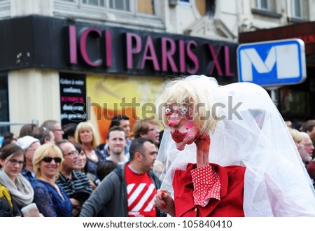 BRUSSELS, BELGIUM-MAY 19: An unknown participant plays weird woman during Zinneke Parade on May 19, 2012 in Brussels. This parade is a biennial urban artistic and free-attendance event