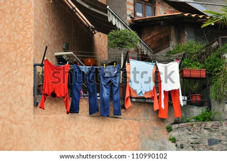 Washed clothes drying on the street side in village