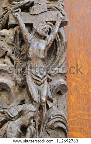 Metal statue on medieval entry door of catholic church