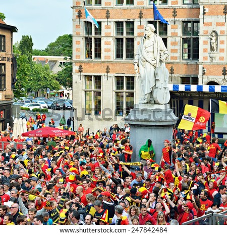HALLE, BELGIUM-JUNY 17, 2014: Football team supporters watch football match on big screen on central square Grote Markt