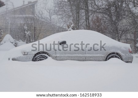 car under the snow blizzard