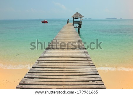 A wooden bridge leading to a wooden pavilion over the sea at Koh Samet island Thailand
