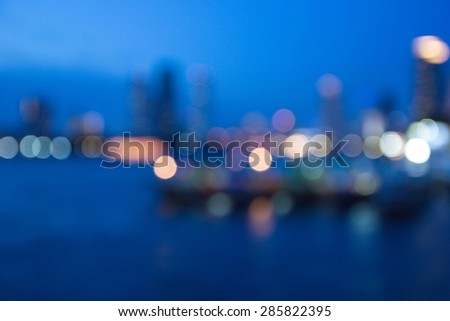 Blur image of Bangkok city with circle bokeh, lights water reflection
