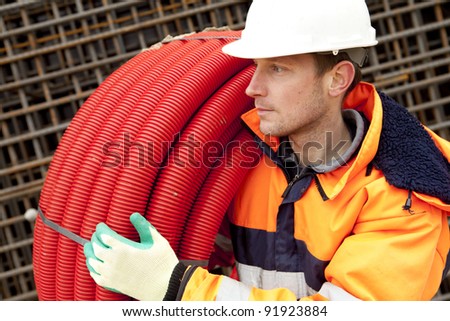 Manual worker with helmet looking at foundation