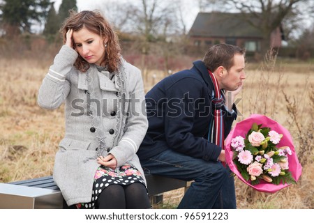 Couple struggling with their relationship while sitting on bench