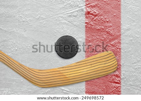 Puck and stick on the red line hockey rink. Texture, background