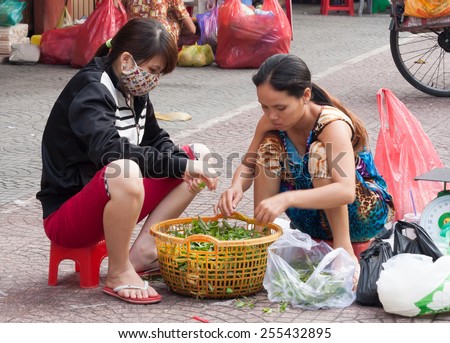 Ho Chi Minh City-Nov 1st 2013: Street vendors sorting vegetables Vendors can be found all over the city.