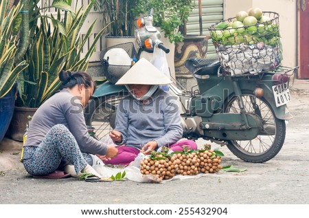 Ho Chi Minh City-Nov 1st 2013: Women sorting longan fruit . Street vendors can be found all over the city