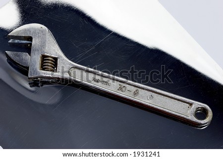 shifting spanner on the scratched reflective surface