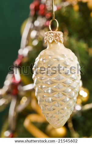 Holiday series: christmas cone decoration on decorated fir background