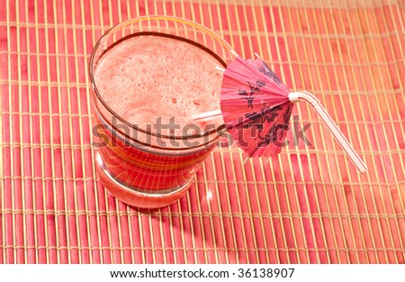 food series: watermelon drink with umbrella straw on pink napkin