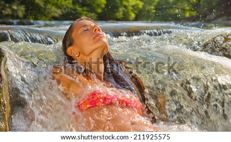 The girl in the waterfall spray