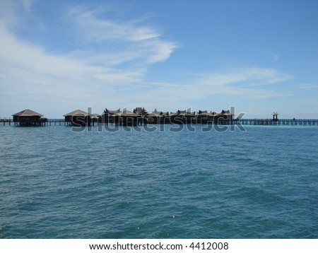 Asian-styled water village against blue sea & blue sky