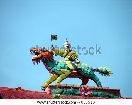God with instruction ride on lion sculptures on oriental temple roof