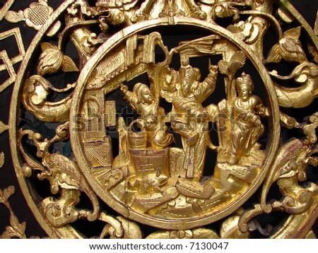 Golden Gods carving in oriental temple