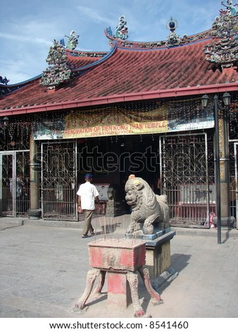 A man walk into the old Chinese temple for praying