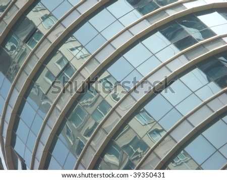 modern skyscraper\'s curve-shaped glass window & reflection