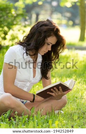 Student with a book in the park