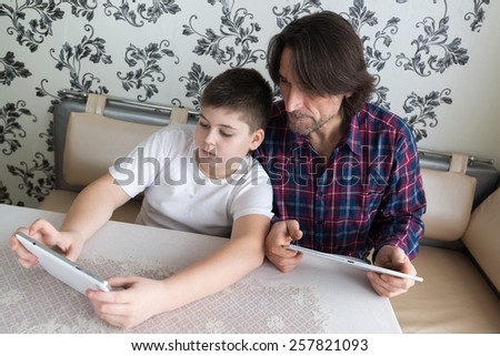 dad and son  with tablet computer indoors