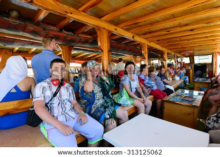 Kemer, Turkey - 06.20.2015. Tourists sitting in a boat on walking tour of the Mediterranean Sea