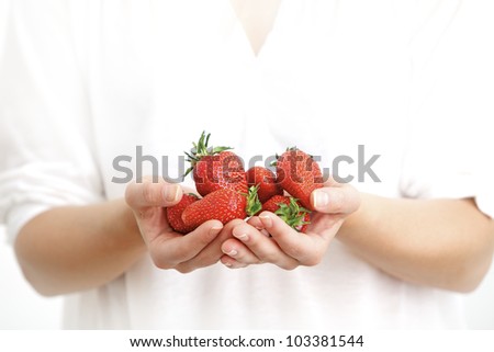 Woman holding fresh strawberries in hands