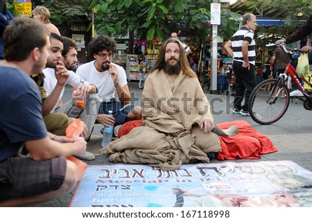 TEL AVIV, ISRAEL - OCTOBER 29: a man sitting at the entry to the Hacarmel market telling stories about the end of the world and saying he is the new messiah,on october 29, 2013, in Tel Aviv Israel