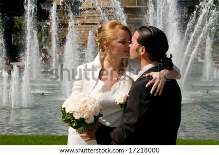 Bride and groom with a fountain background