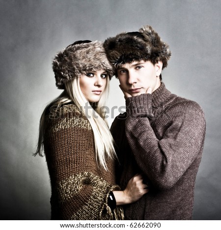Winter fashion beautiful man and woman studio photo shooting