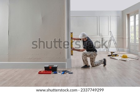 Similar – Image, Stock Photo Renovation concept. Male worker plastering a wall using a long spatula