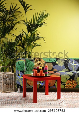 colored sofa  red coffee table and colored candle interior design