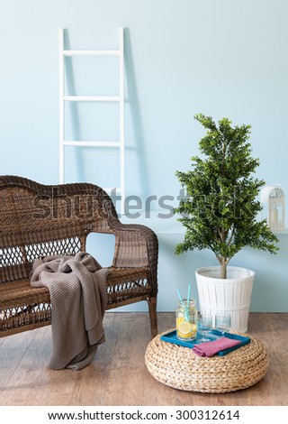 blue wall interior style with wicker sofa and stairs