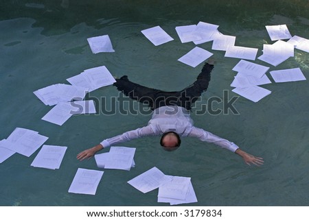 Image of a man drowning in paper work