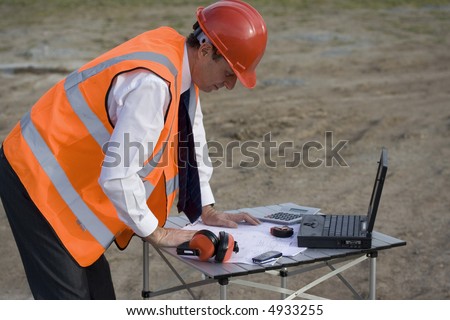 Image of a white collar worker on a building site