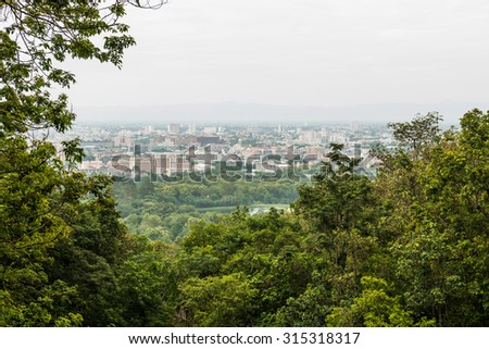 Chiangmai city view with tree foreground, Thailand.