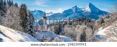 Panoramic view of beautiful winter landscape in the Bavarian Alps with pilgrimage church of Maria Gern and famous Watzmann massif in the background, Nationalpark Berchtesgadener Land, Bavaria, Germany