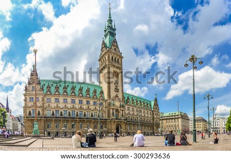 Beautiful view of famous Hamburg town hall with dramatic clouds and blue sky at market square near lake Binnenalster in Altstadt quarter, Hamburg, Germany