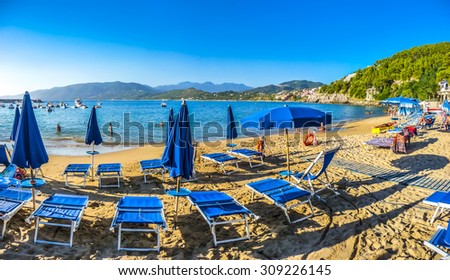 Beautiful view of typical vacation beach with beach chairs and sun shades in golden evening light at Capo Palinuro, Campania, Italy