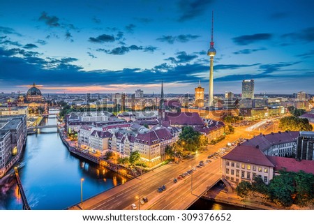 Aerial view of Berlin skyline with dramatic clouds in twilight during blue hour at dusk, Germany