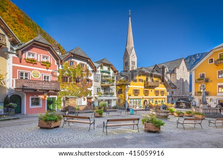 Scenic picture-postcard view of the historic town square of Hallstatt with traditional colorful houses and church at Hallstatter See in the Austrian Alps in fall, region of Salzkammergut, Austria Stock fotó © 