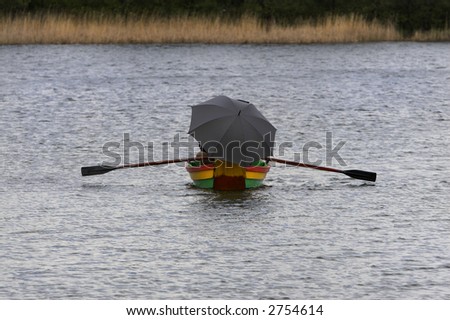 Boat on the lake during the rain. Picture taken in Lithuania