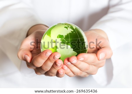 Environmental protection concept with glass globe in hand