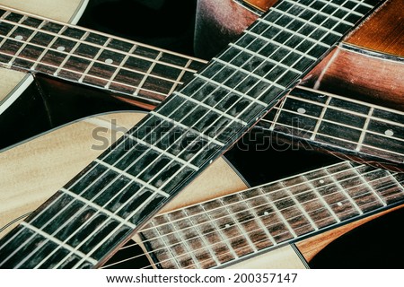 Vintage Acoustic Guitar Necks Crossed. Three acoustic guitars with their necks crossed.
