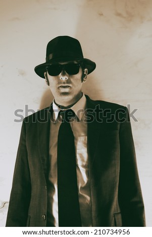 Man Hat and Suit Film Noir. Man in suit, hat and sunglasses.
