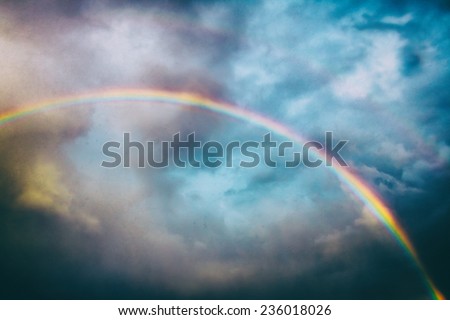 Classic Rainbow. A rainbow across the sky, edited with vintage film effects.