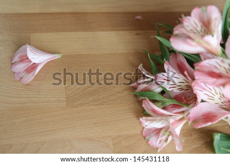 Pink flower bouquet on wooden tabletop