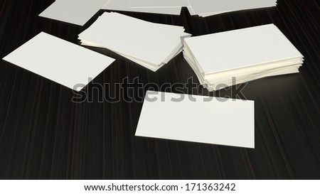 many blank visit cards lying on dark wooden surface