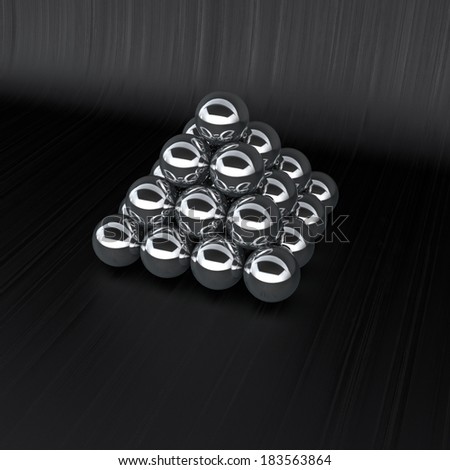 glossy metal spheres made in a pyramid on dark wooden background